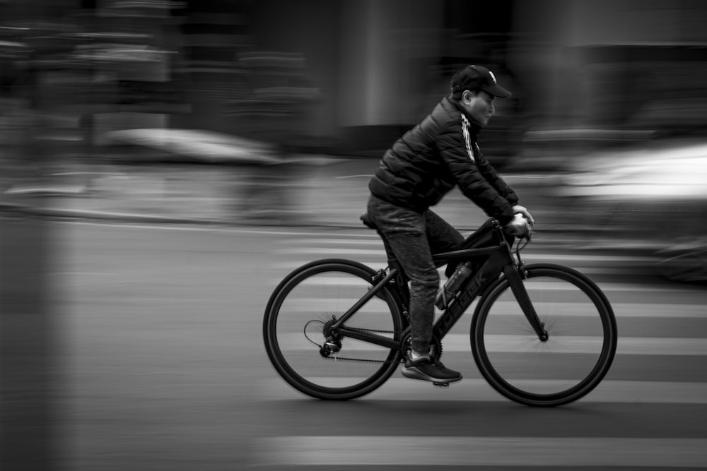 a man riding a bike down a street