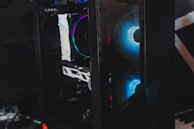 Side view of a mntob gaming case highlighting its tempered glass panel and colorful internal lighting.