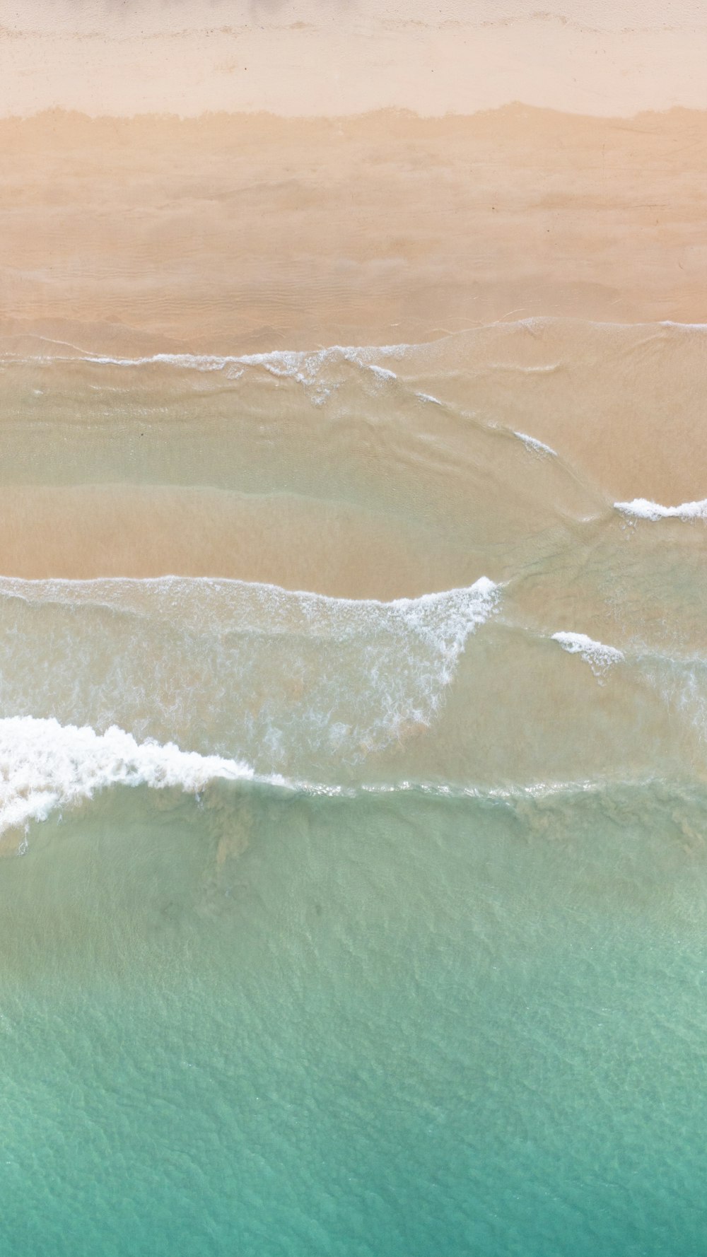 a man riding a surfboard on top of a wave in the ocean