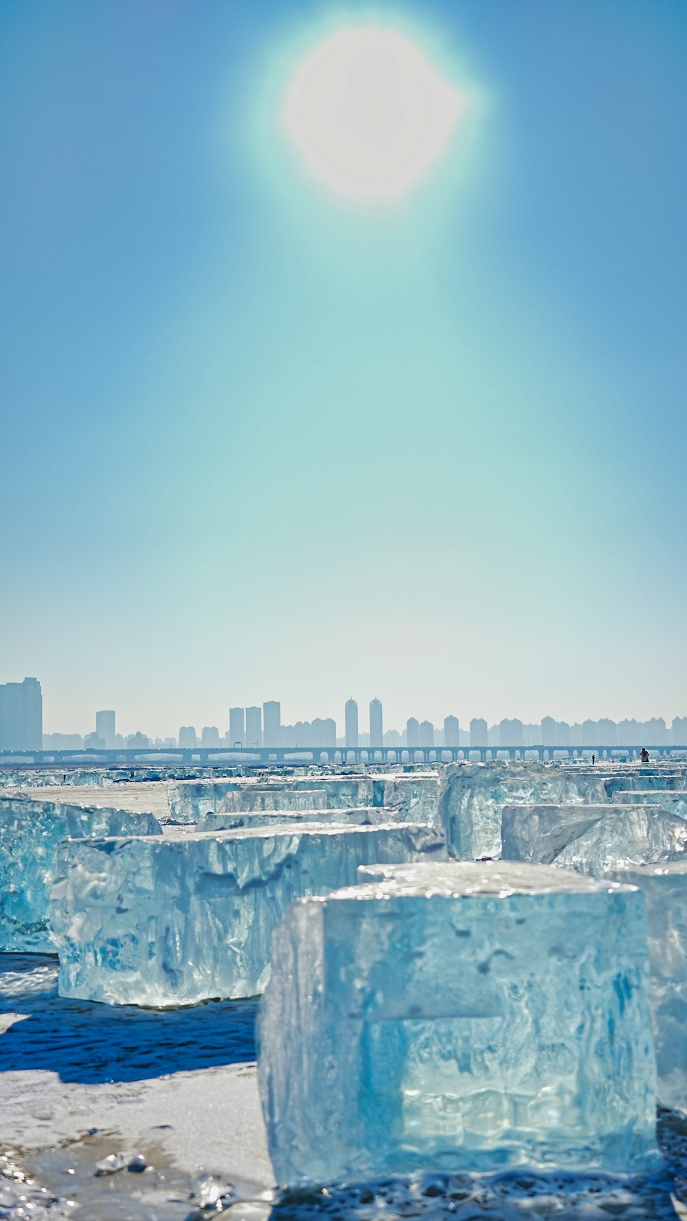 the sun is shining over the icebergs in the water