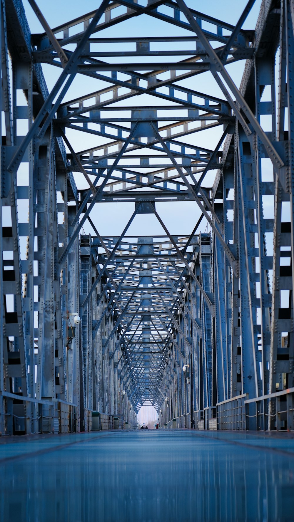 a large metal bridge spanning over a body of water