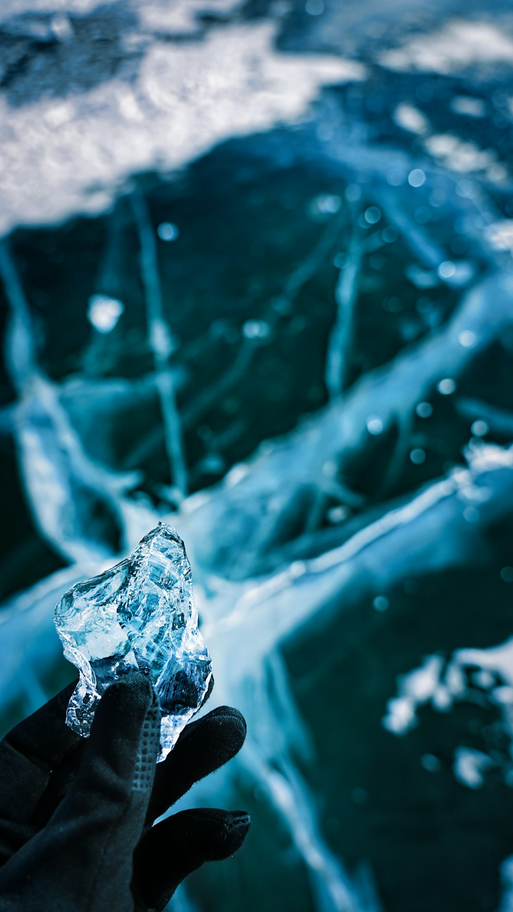 a person holding a piece of ice in their hand