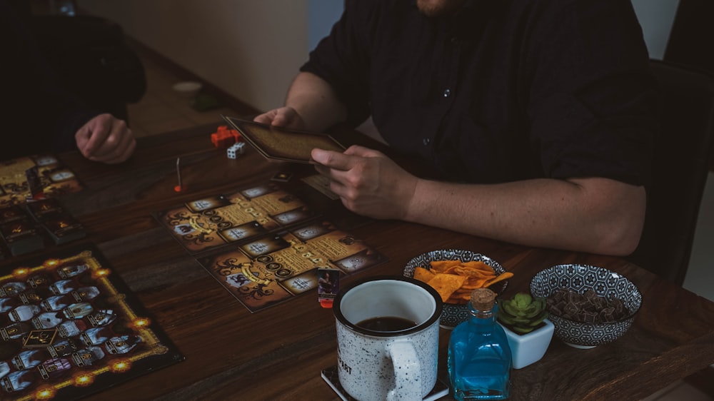 a man sitting at a table playing a board game