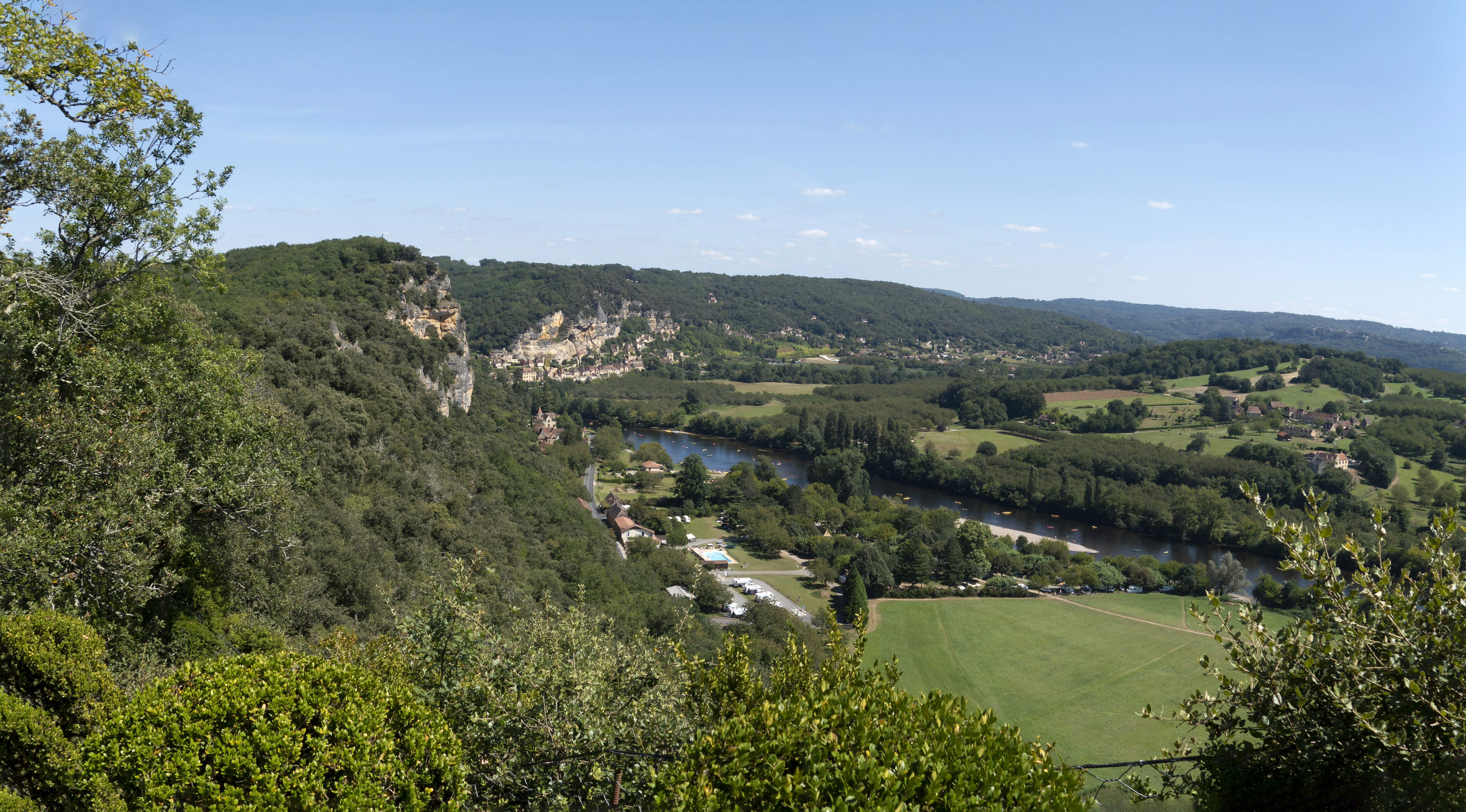a scenic view of a valley with a river running through it