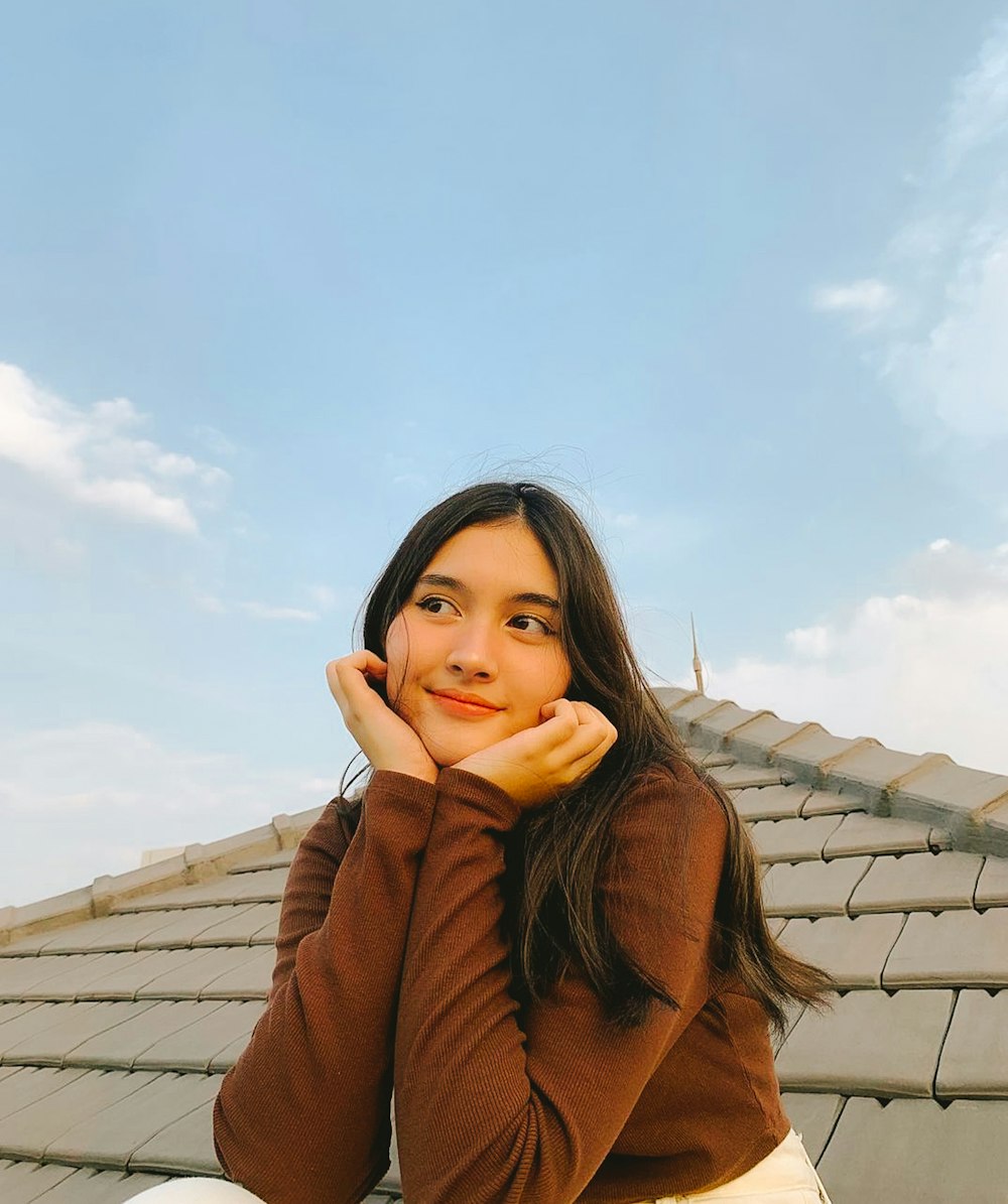 a woman sitting on the roof of a building