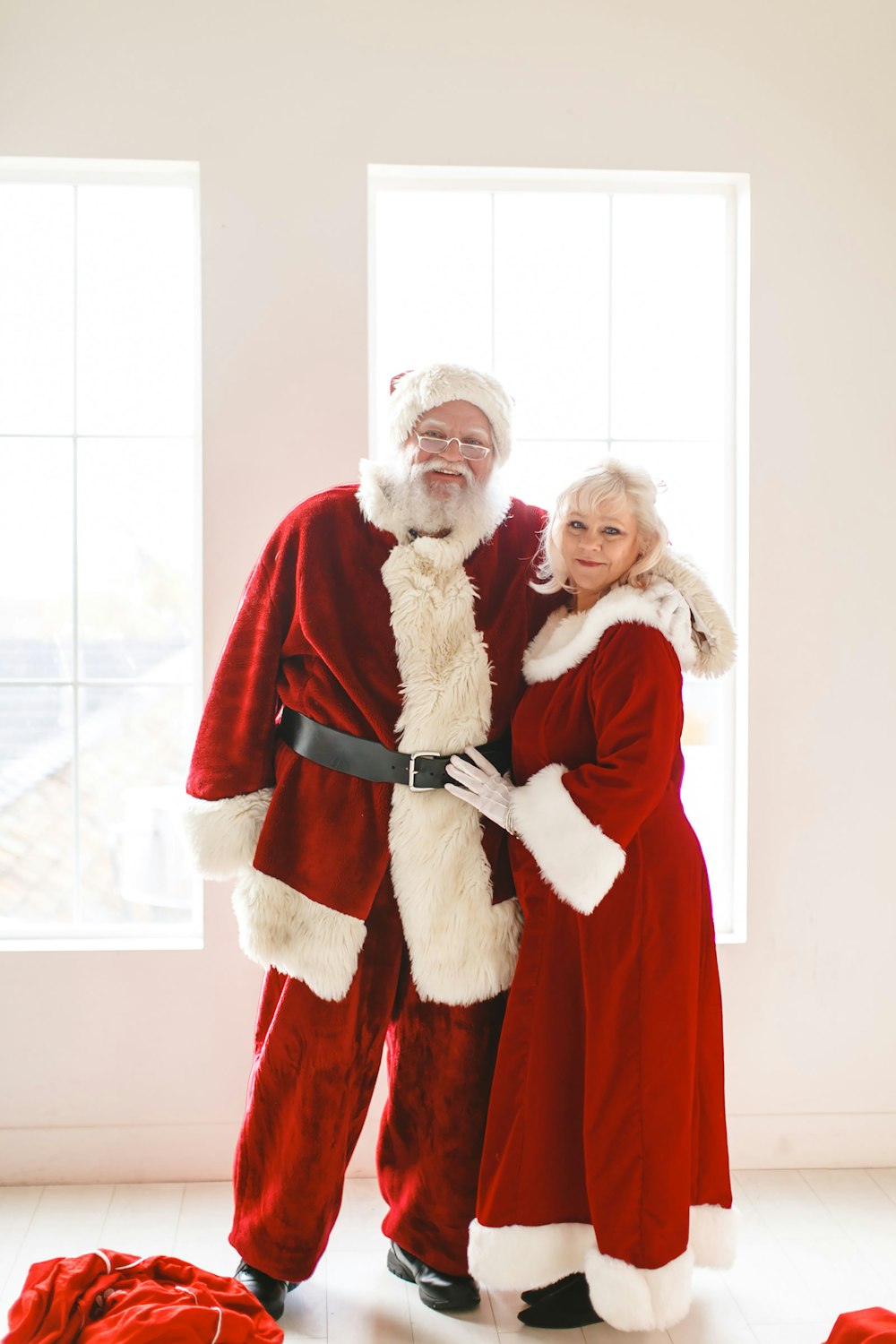 a man and a woman dressed as santa claus