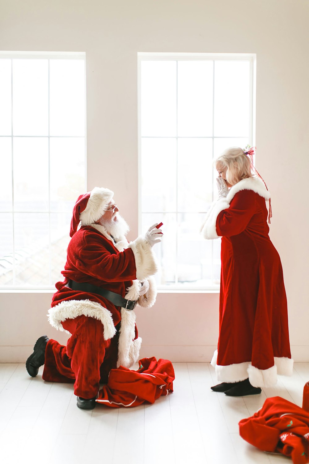 a man dressed as santa claus and a woman dressed as santa claus