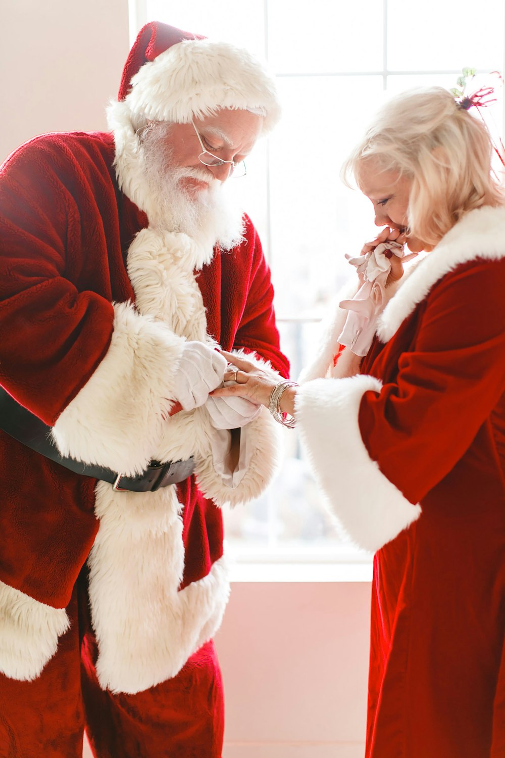 a man and a woman dressed as santa claus