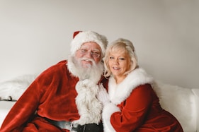 a man and a woman dressed as santa claus