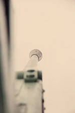 Close-up of a sleek telescopic pole extending smoothly against a deep blue background.