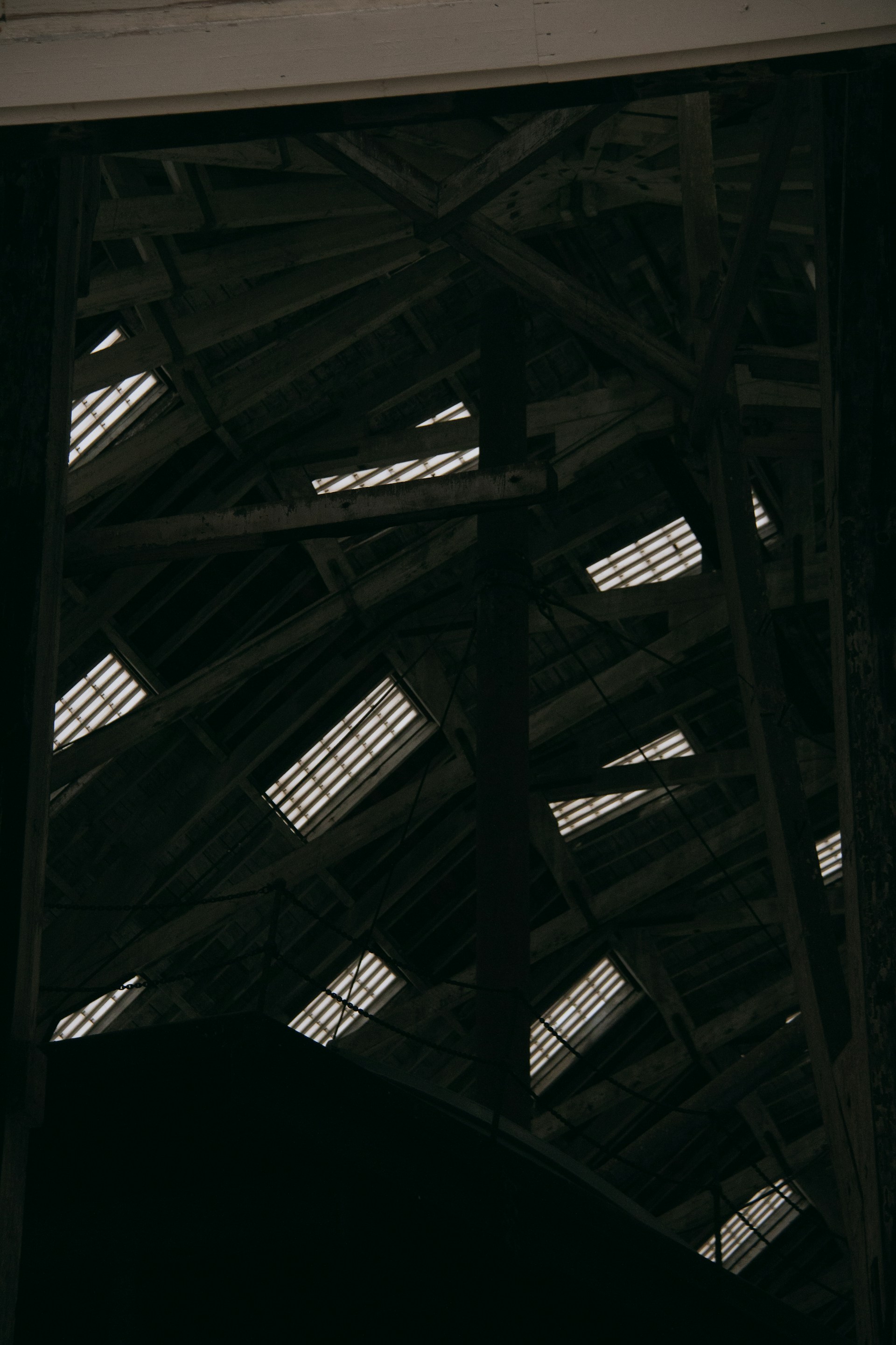 a black and white photo of a clock in a building
