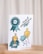 A set of colorful illustrations on a card, including a blue rosette with the word 'feey', a trophy with leaves at the base, a cartoon character with a blue hat holding a '#1' foam finger, and the phrase 'absolut philodentastisch' with decorative leaves.