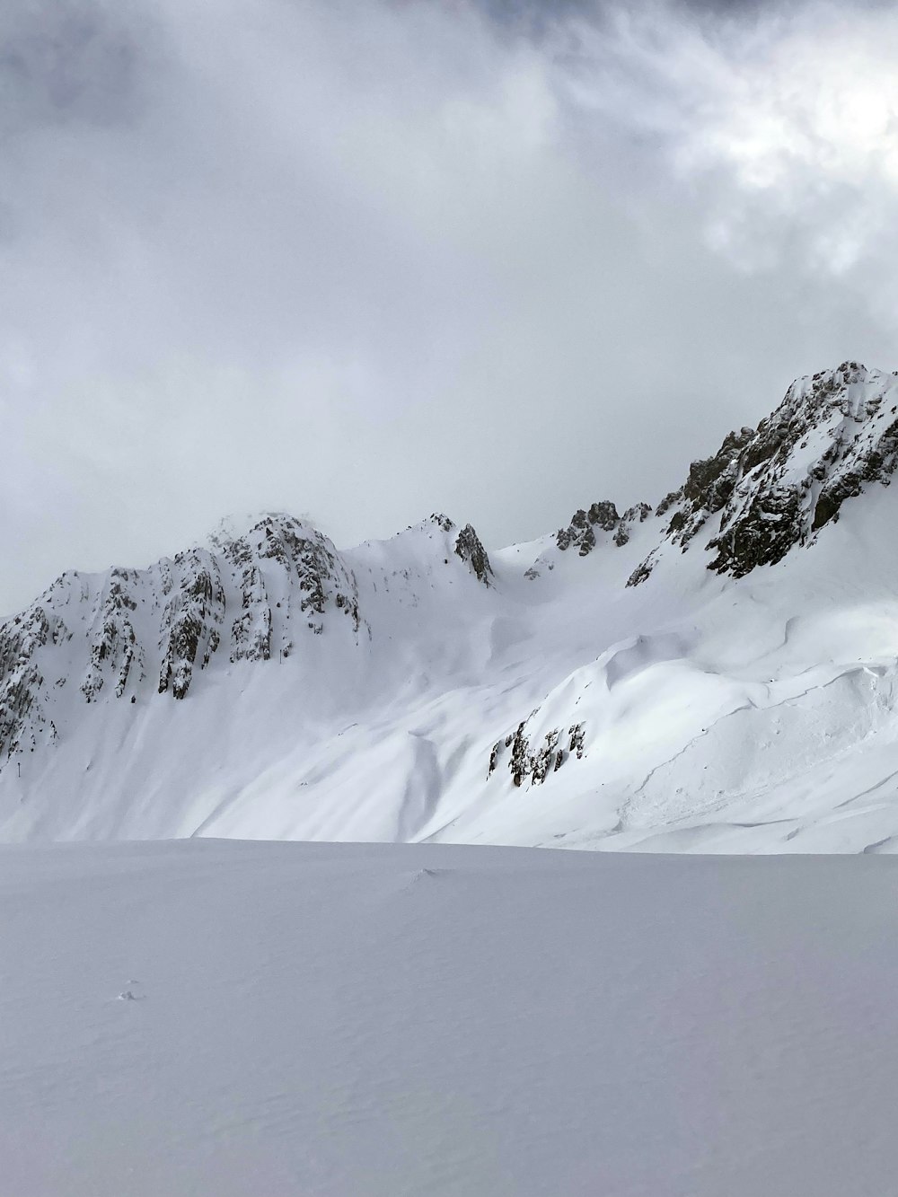 a man riding skis down a snow covered slope