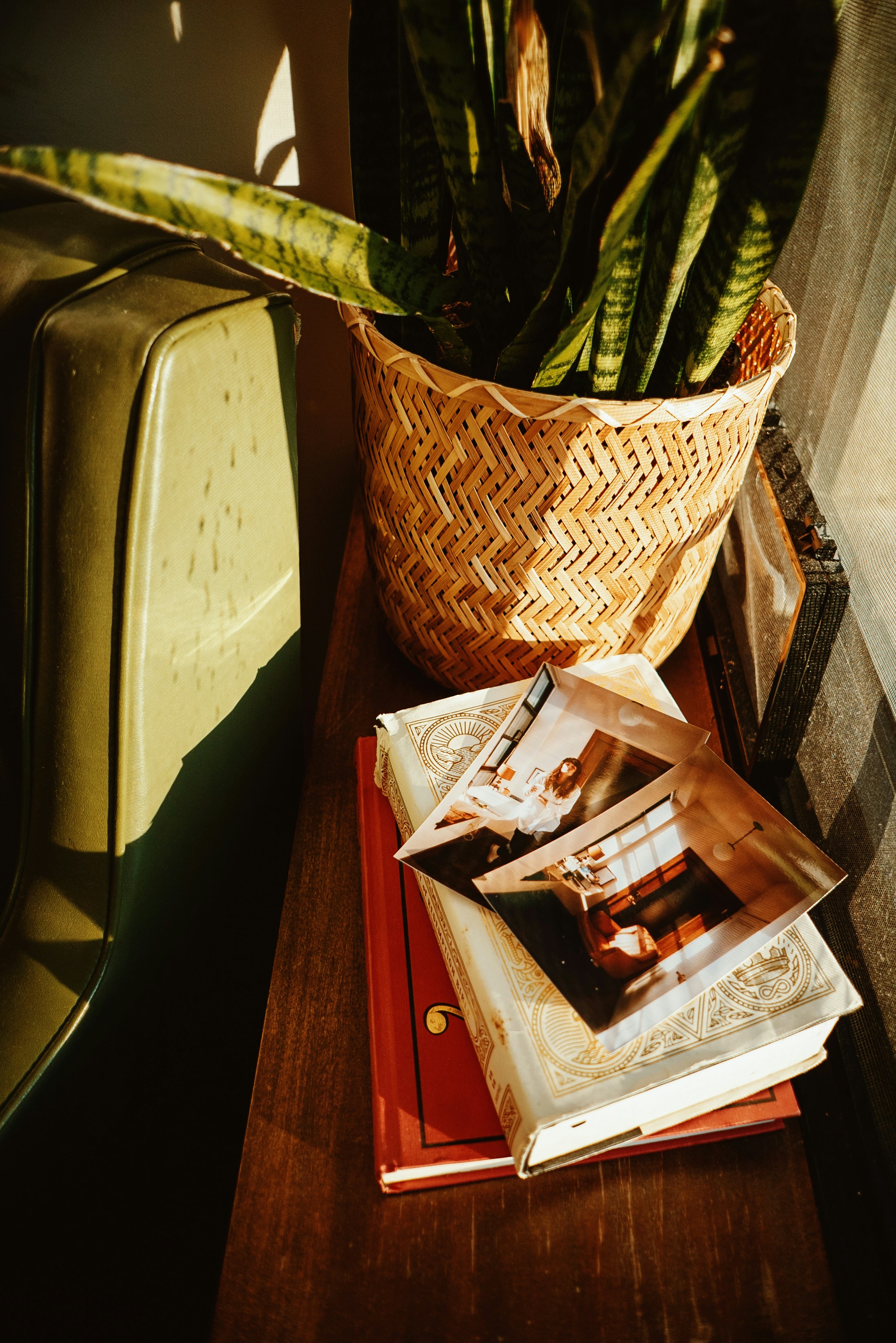 a wooden table topped with a basket filled with books