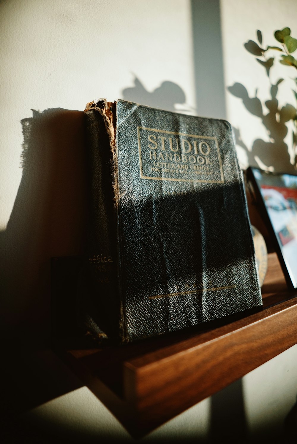 a book sitting on top of a wooden shelf