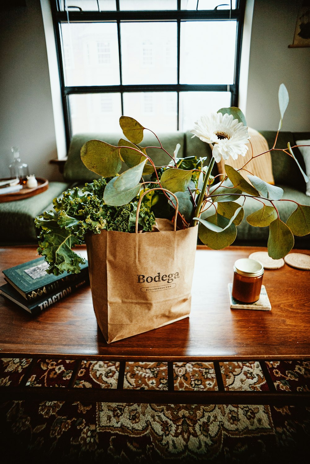 a brown paper bag with a plant in it on a table