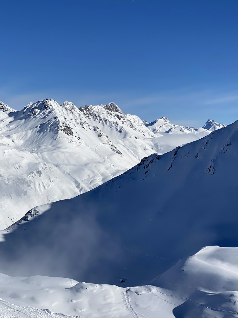 a person riding skis on top of a snow covered slope