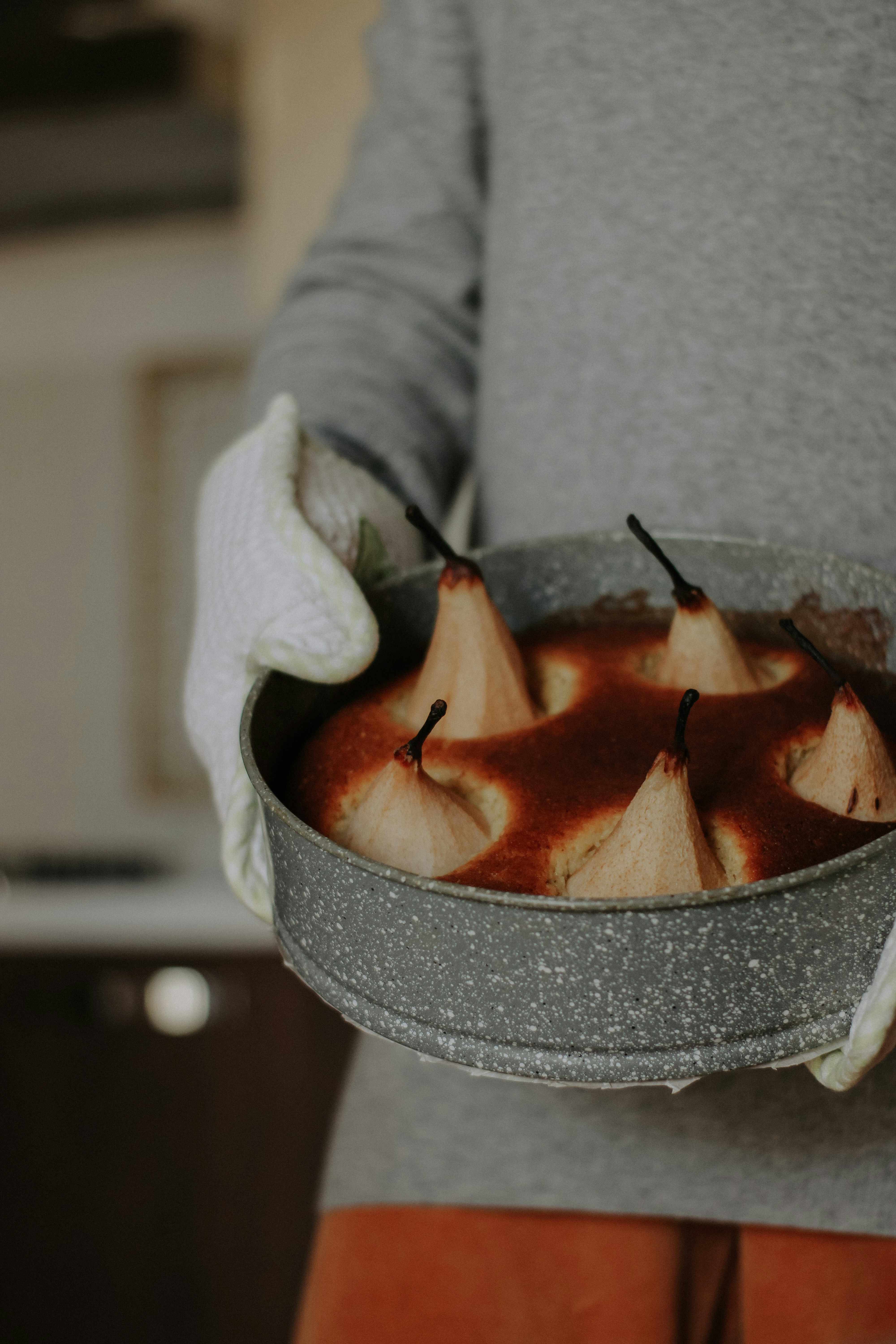 a person holding a metal pan filled with food