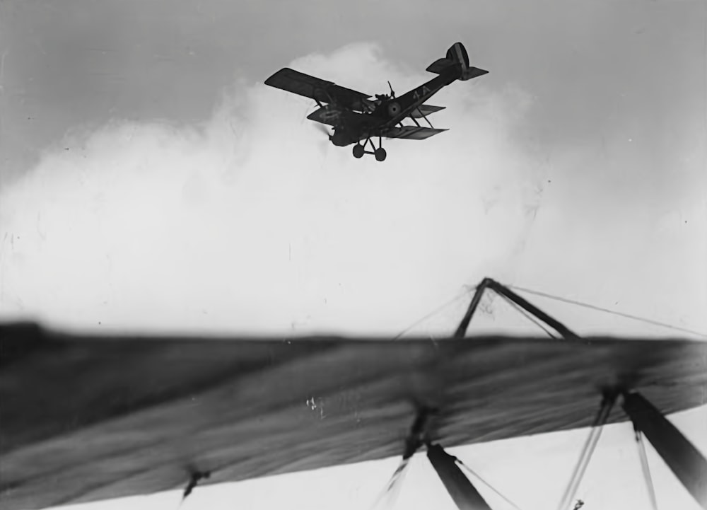 a small airplane flying over a large body of water