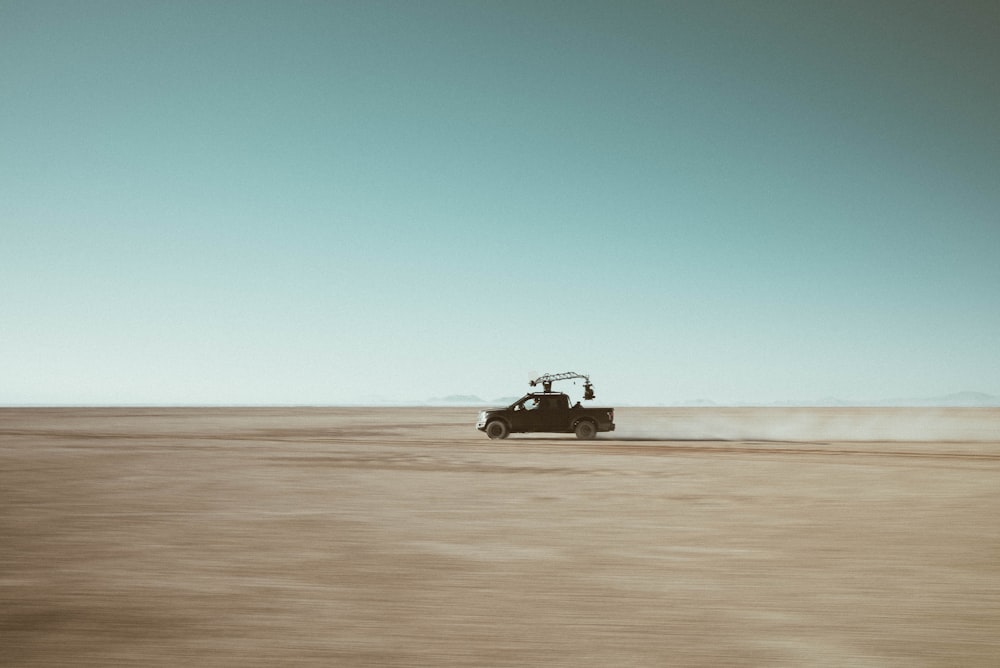 a car driving in the middle of a desert