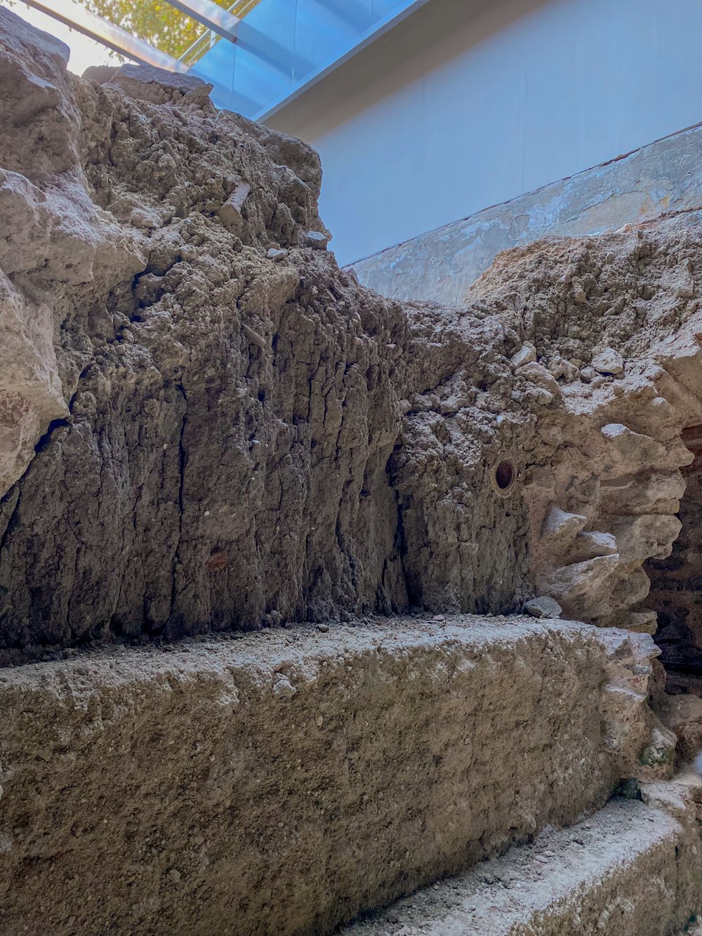 a large rock formation with a skylight above it