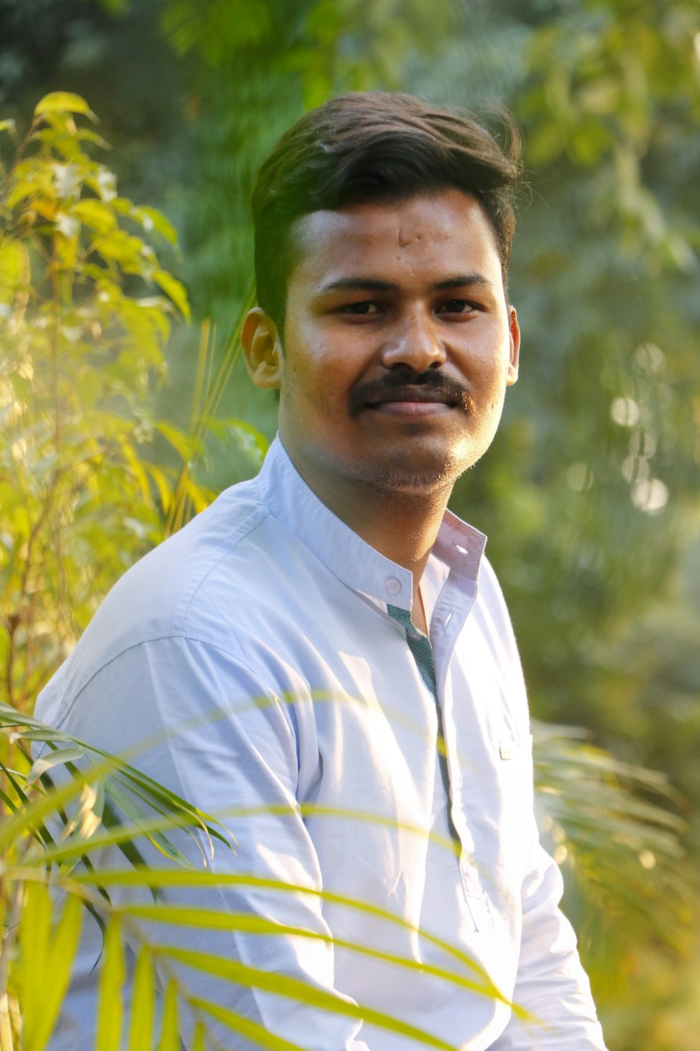 a man standing in front of some trees