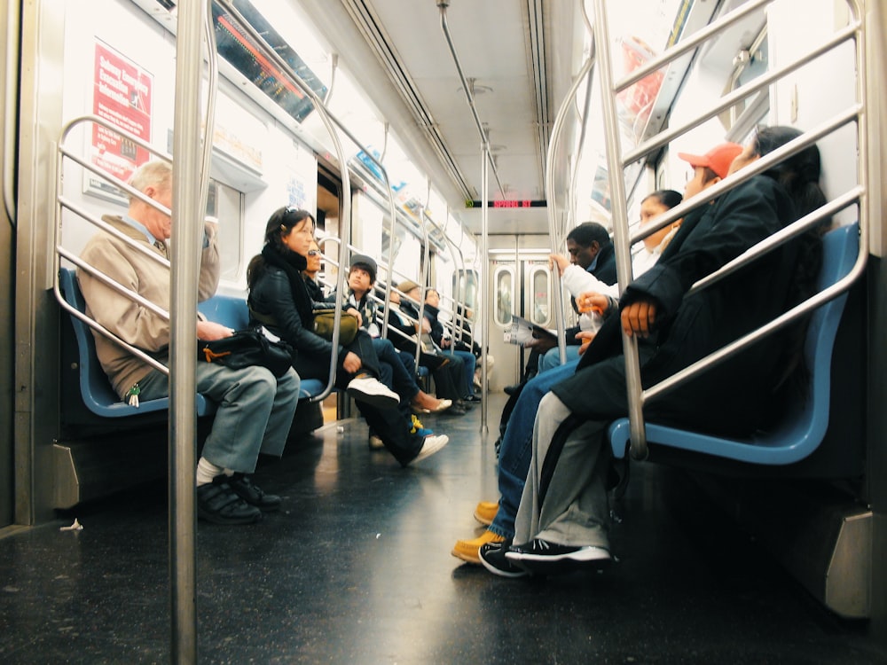 a group of people sitting on a subway train