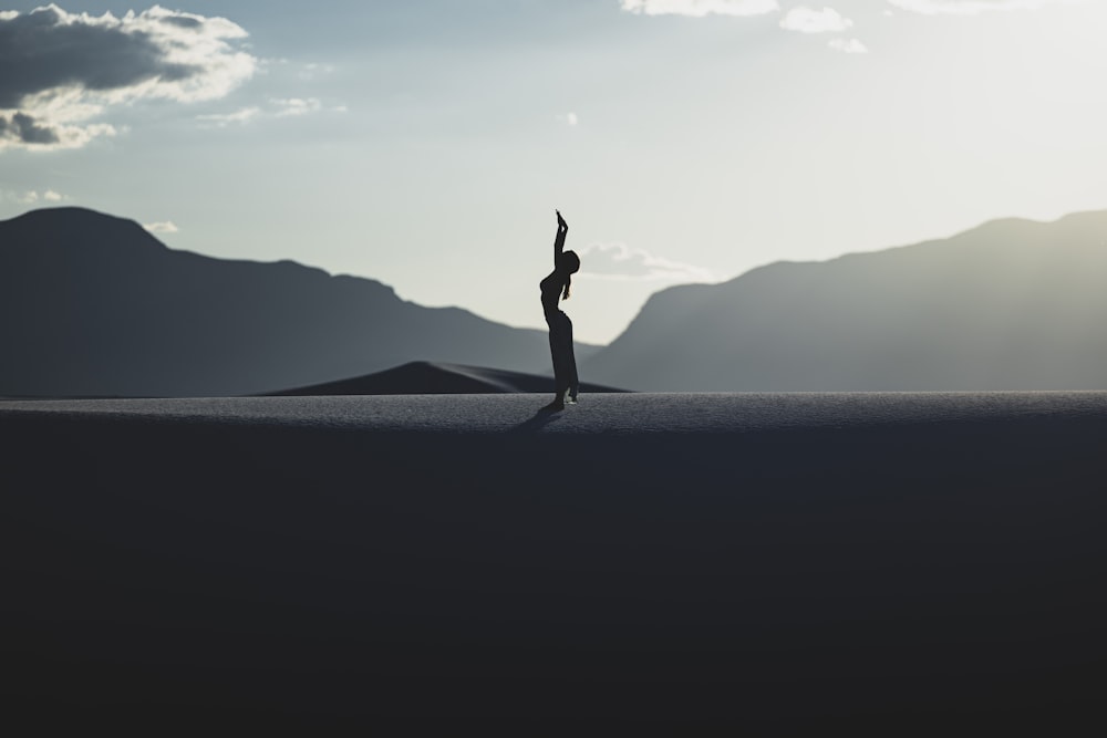 a person standing in the middle of a desert