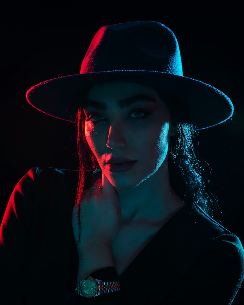 a woman wearing a black hat and a watch