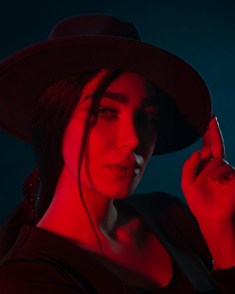 a woman wearing a hat and smoking a cigarette