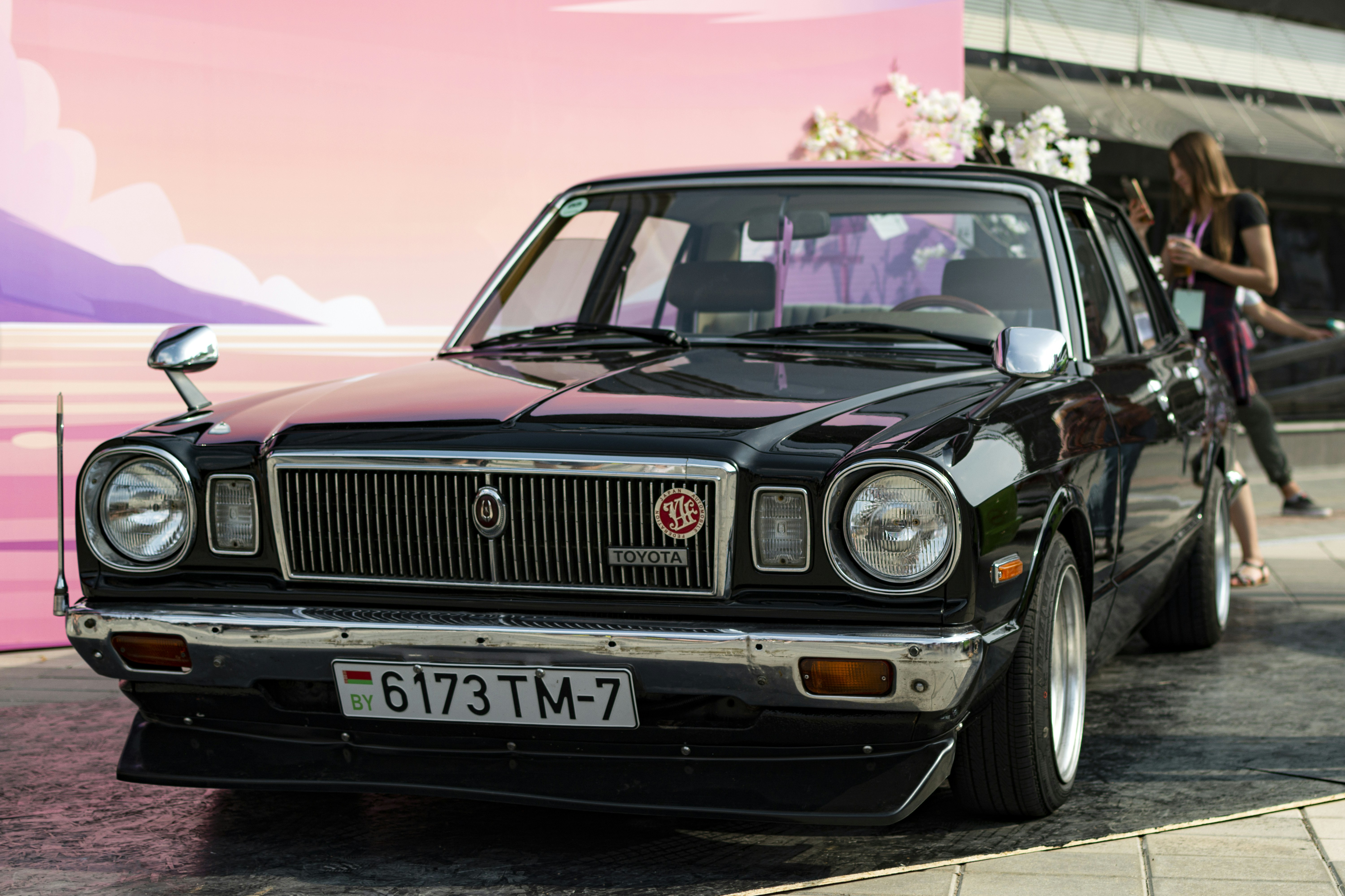a black car parked in front of a building