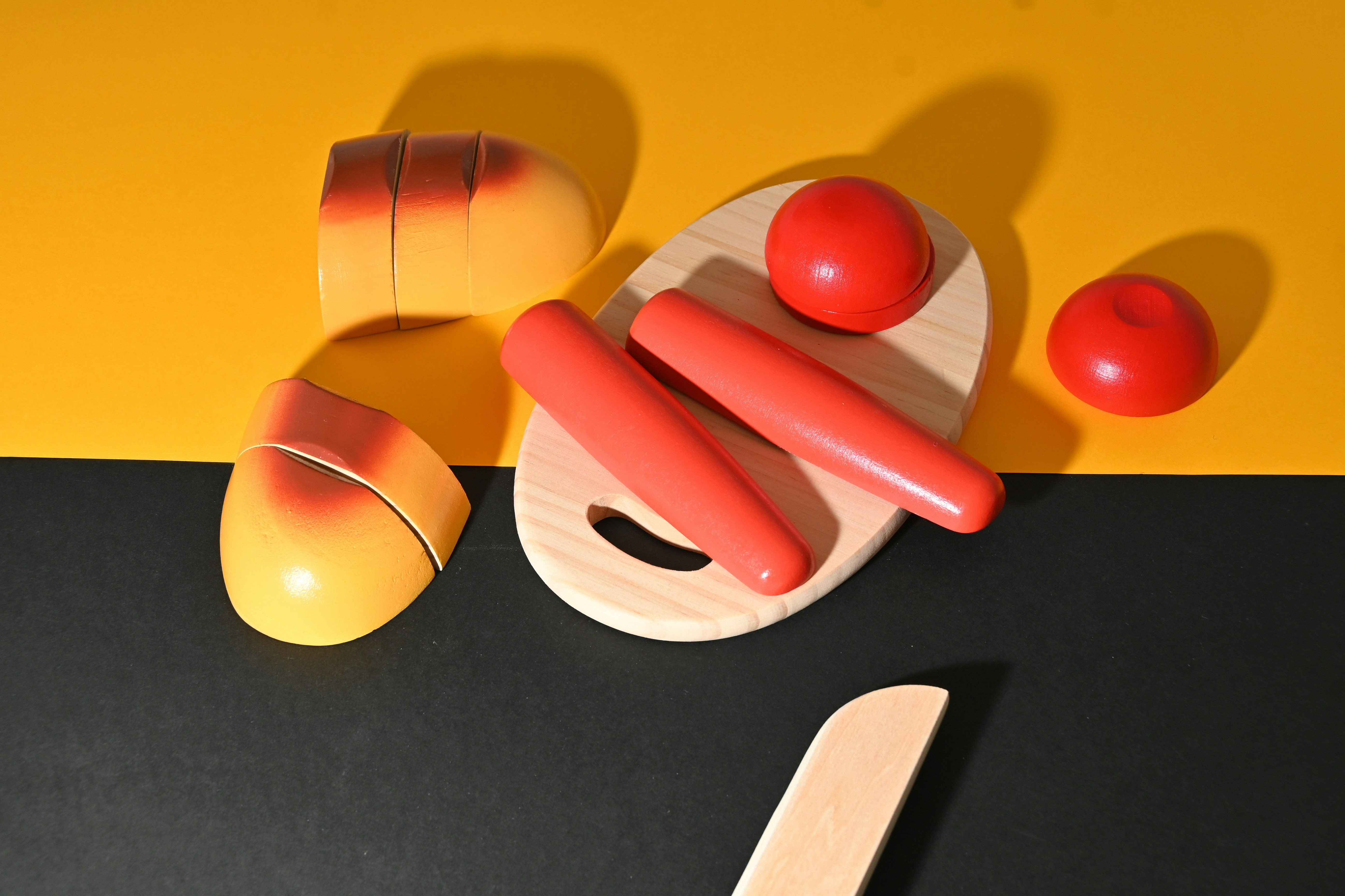 a wooden toy with a red and yellow design on it