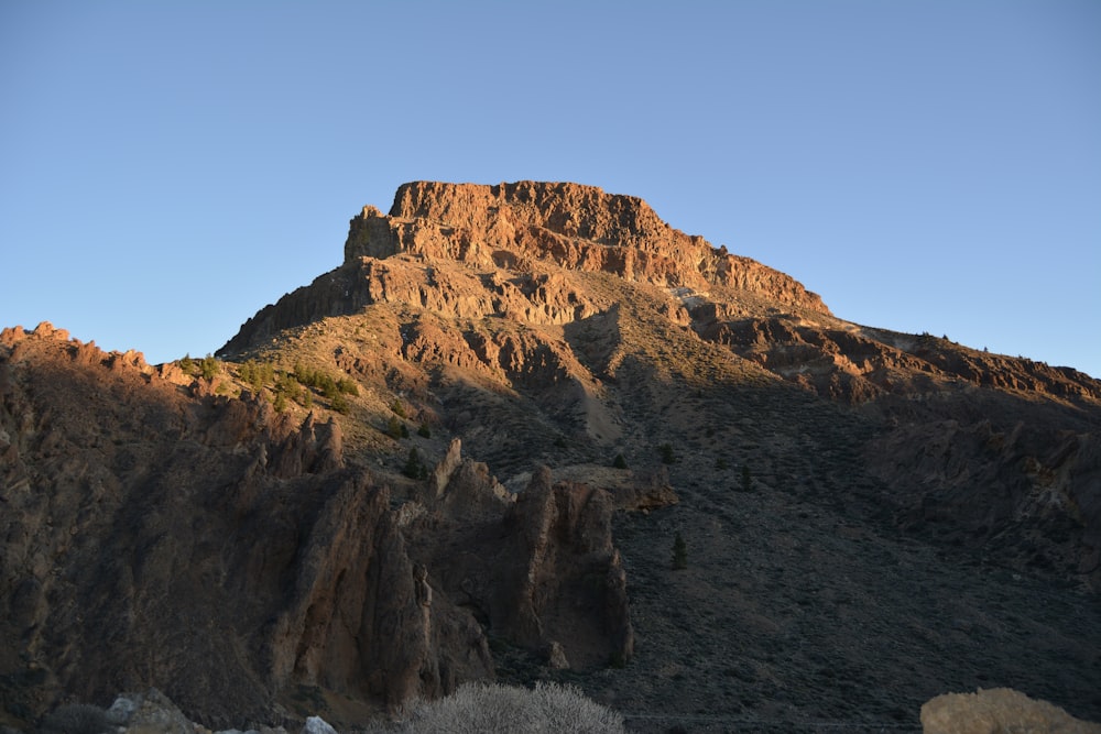 a very tall mountain with a sky in the background