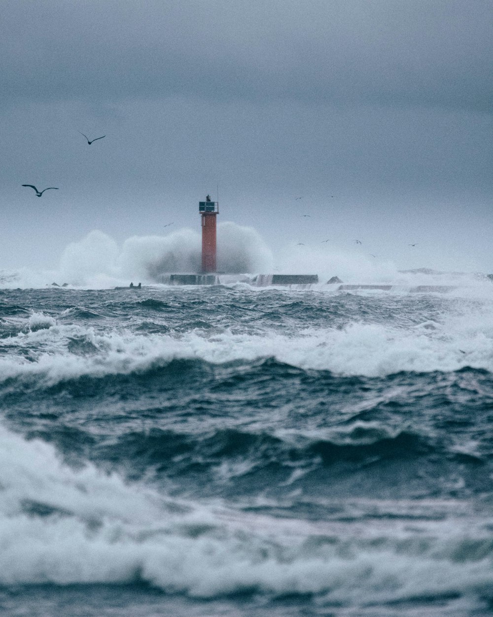 a lighthouse in the middle of a large body of water