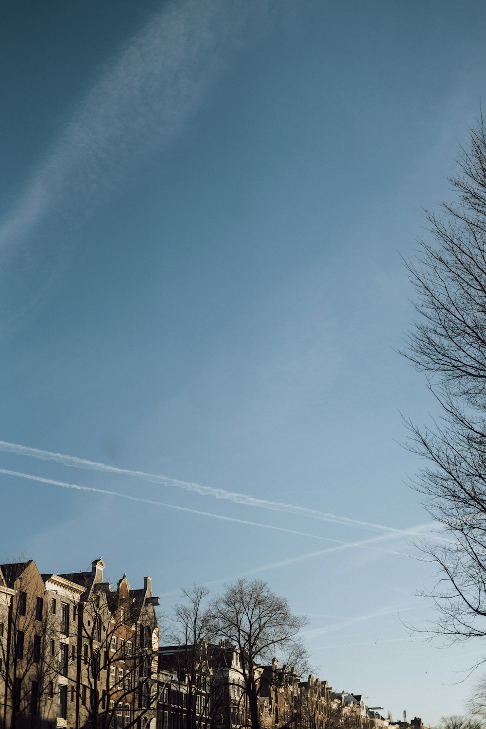 a clear blue sky with some contrails in the sky