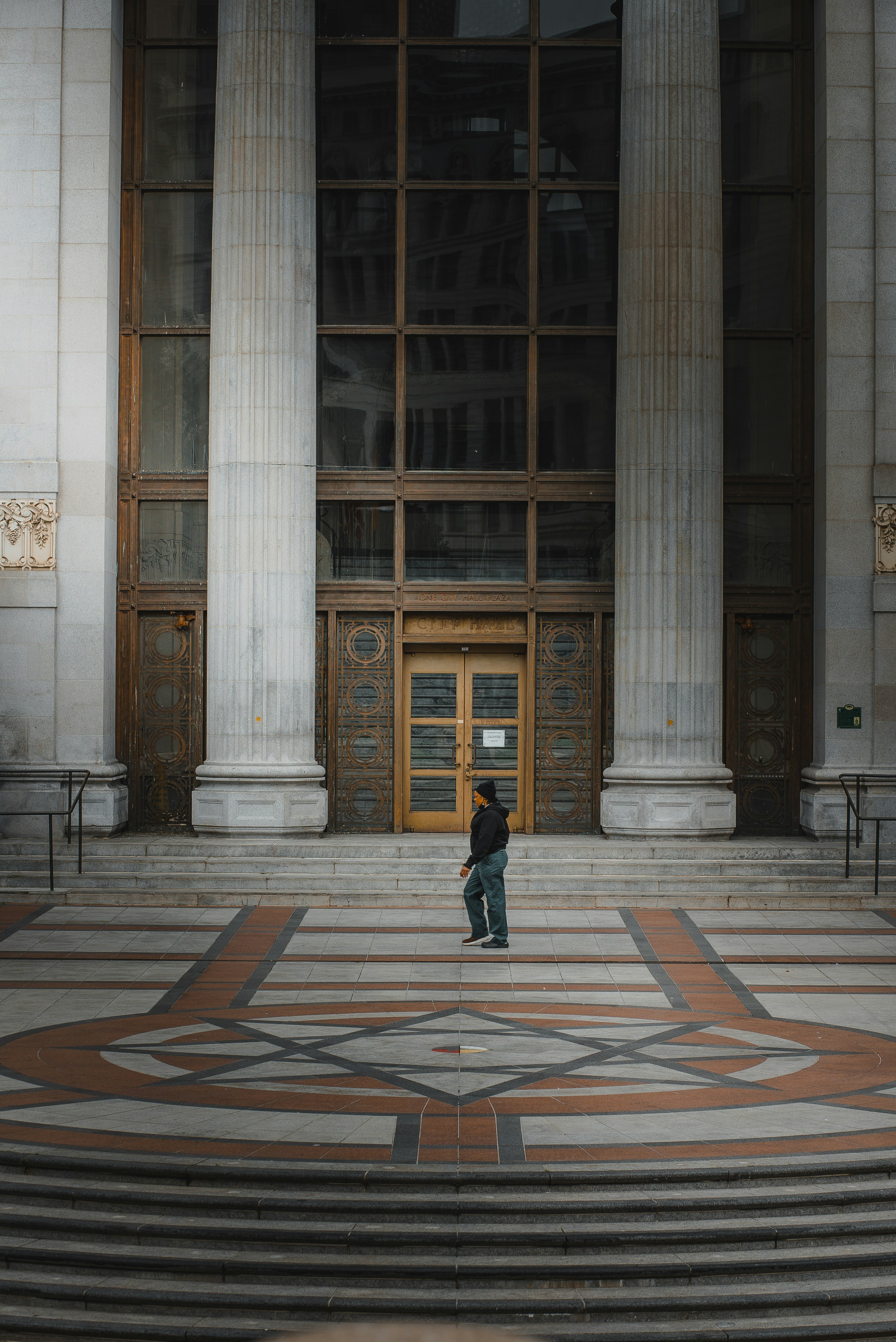 a person standing in front of a large building