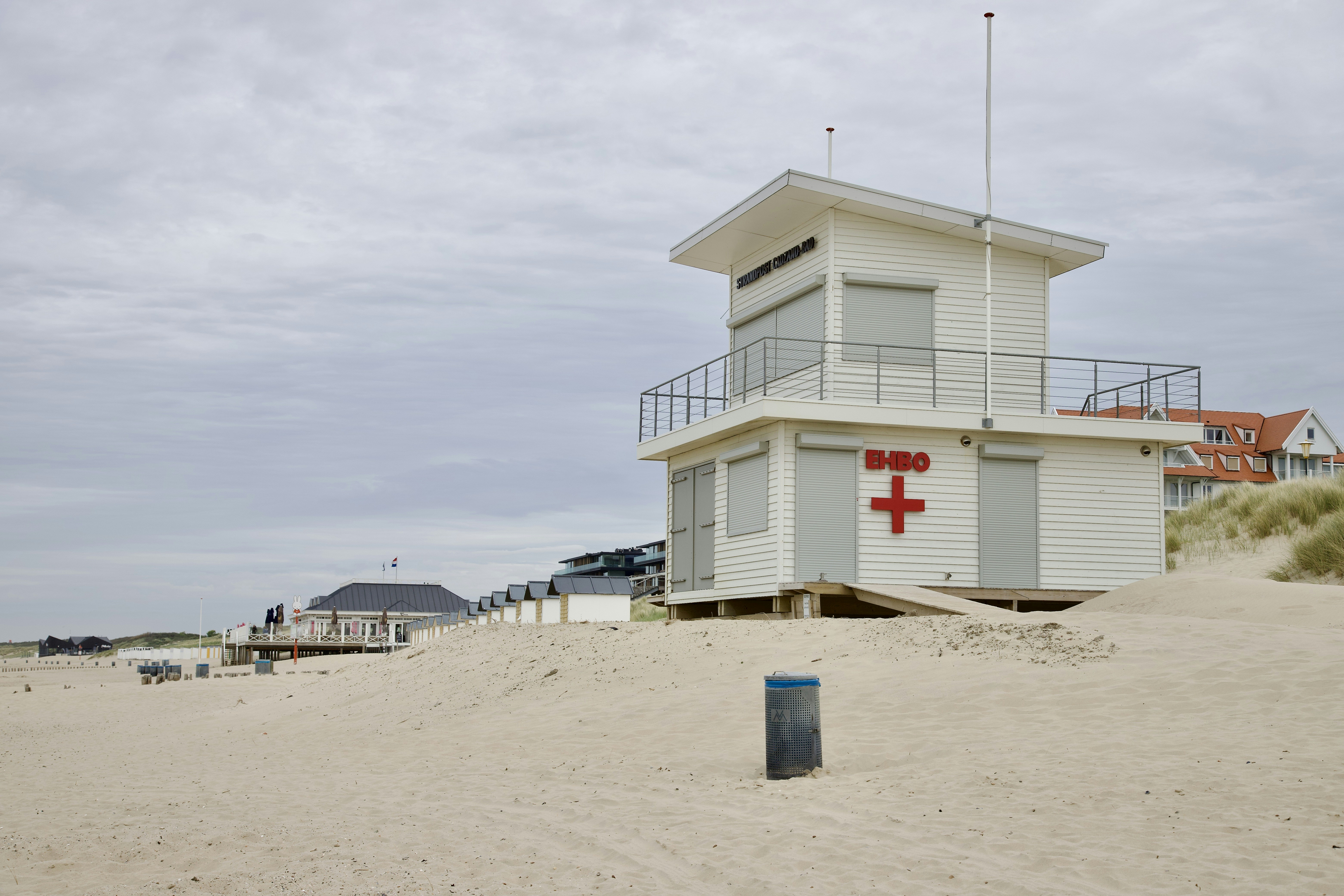 a lifeguard tower on the beach with a lifeguard station in the background