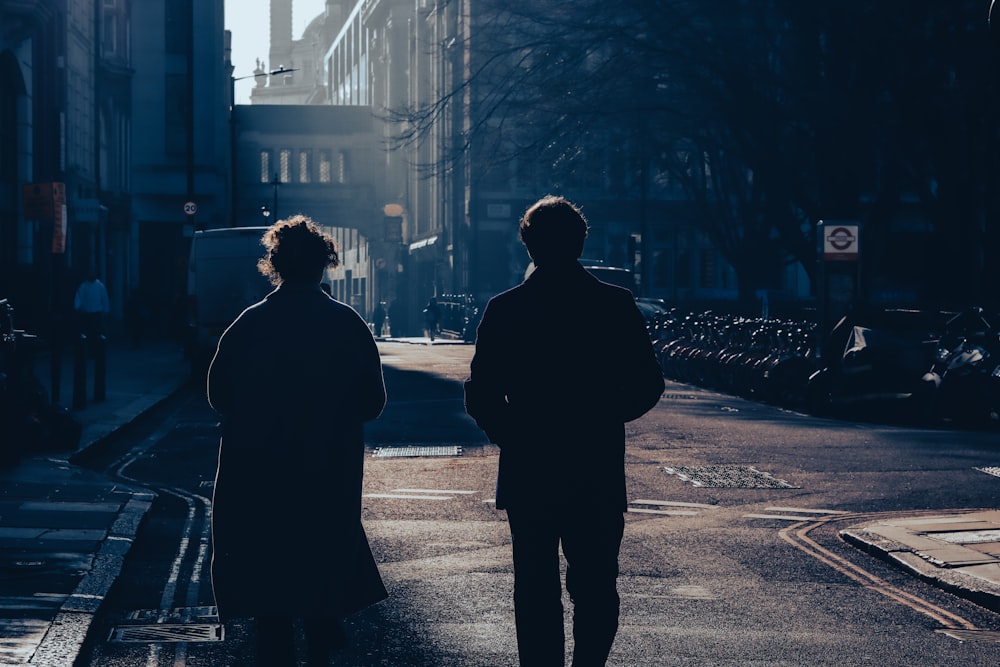 a couple of people walking down a street