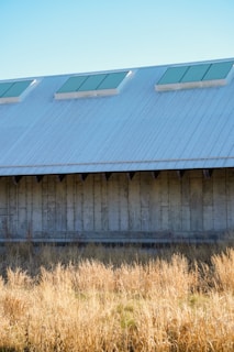 Wide shot of a spacious agricultural warehouse framed by metal structures