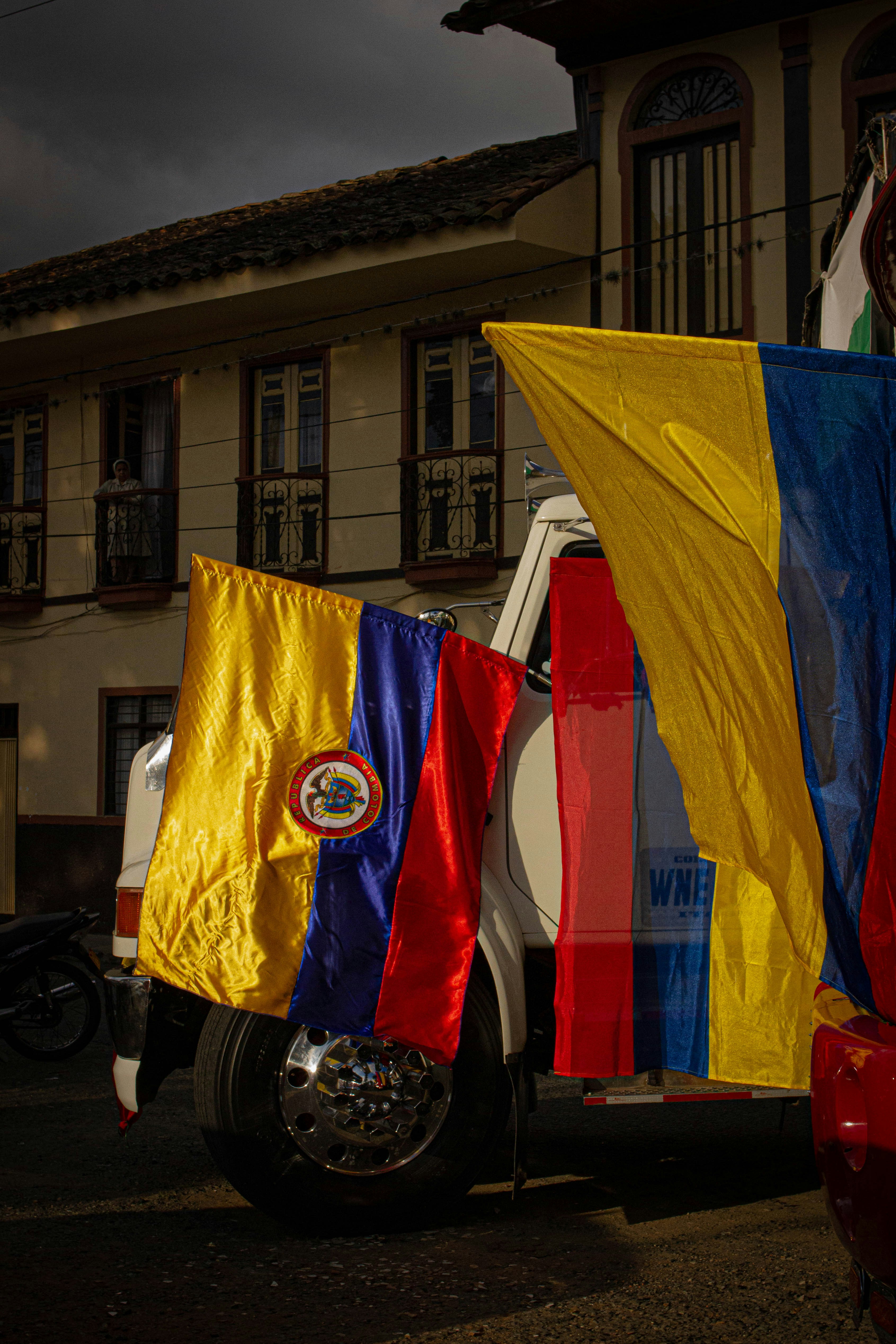 a truck with a bunch of flags on the back of it