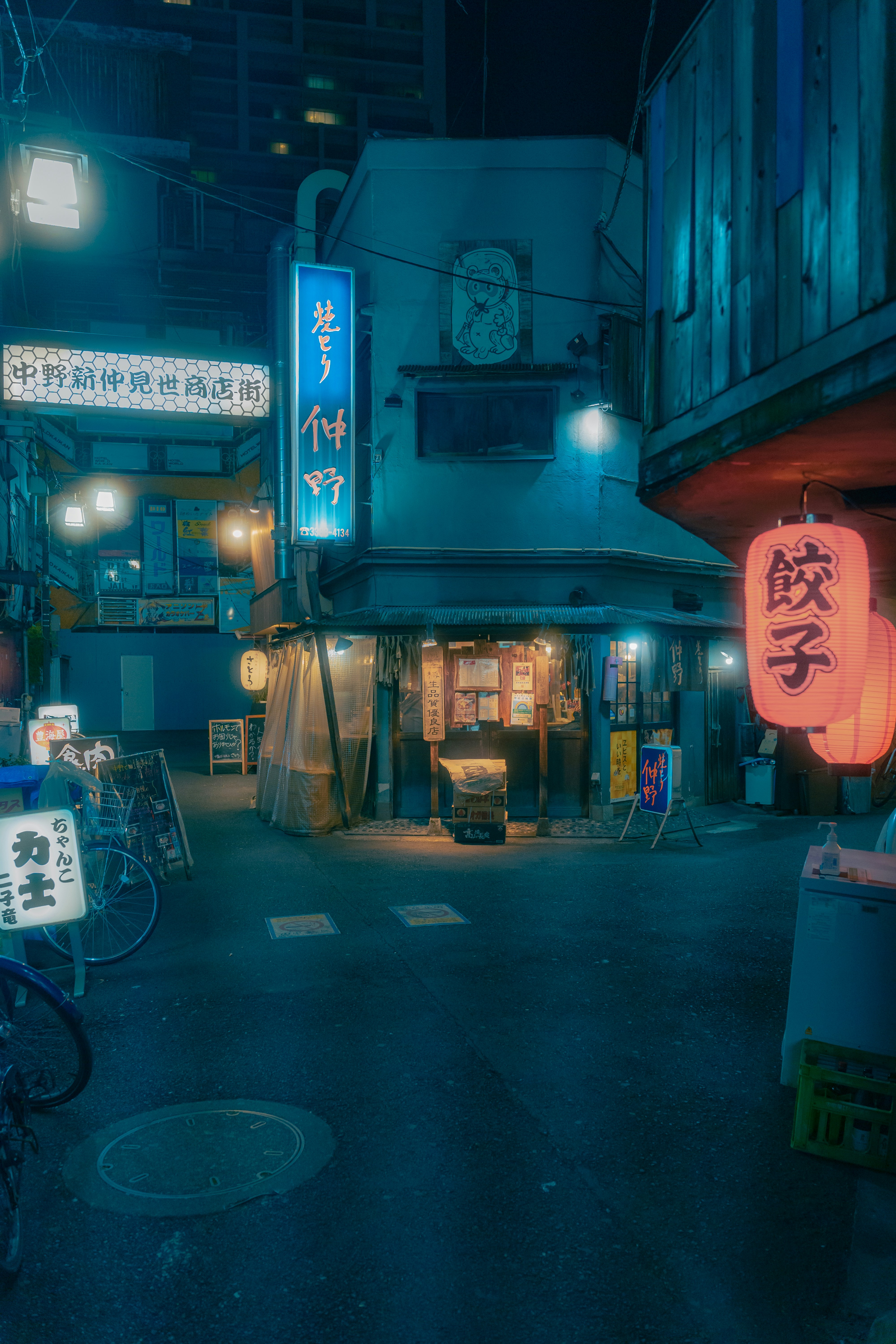 a city street at night with a neon sign