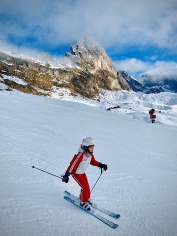 A young girl skiing down a snowy slope in the French Alps.