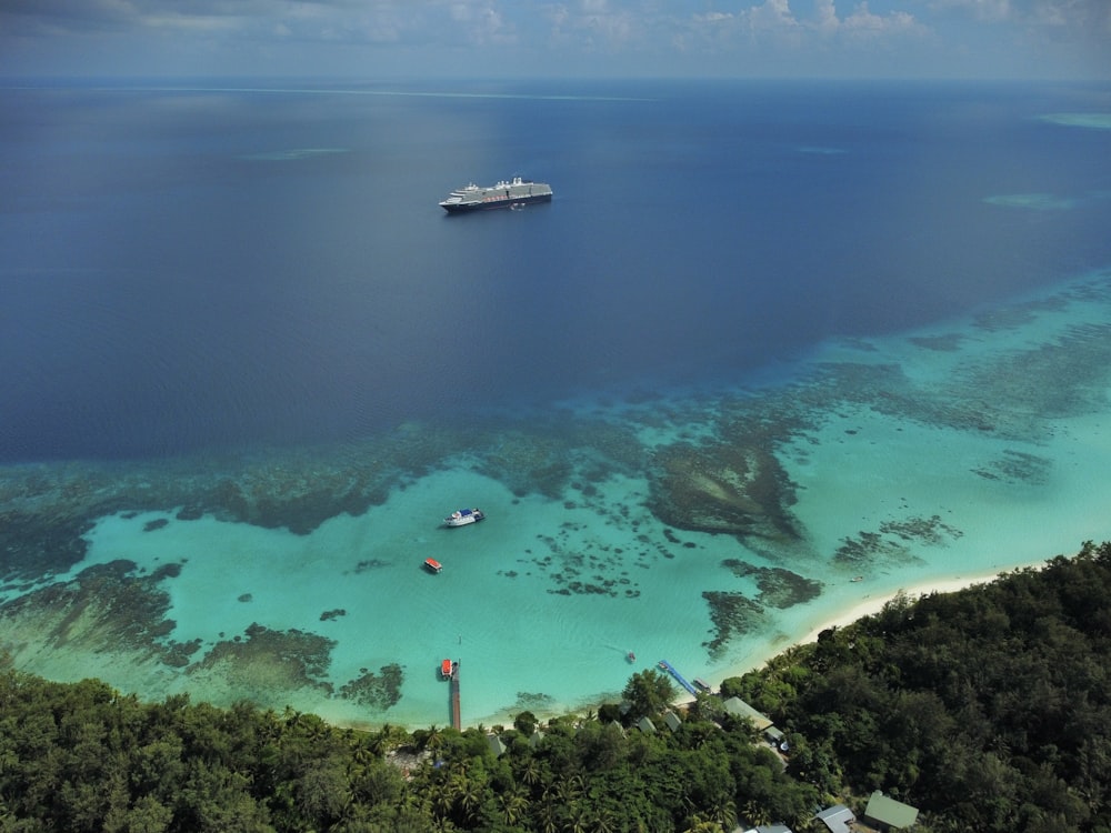 a cruise ship is in the water off the coast of a tropical island