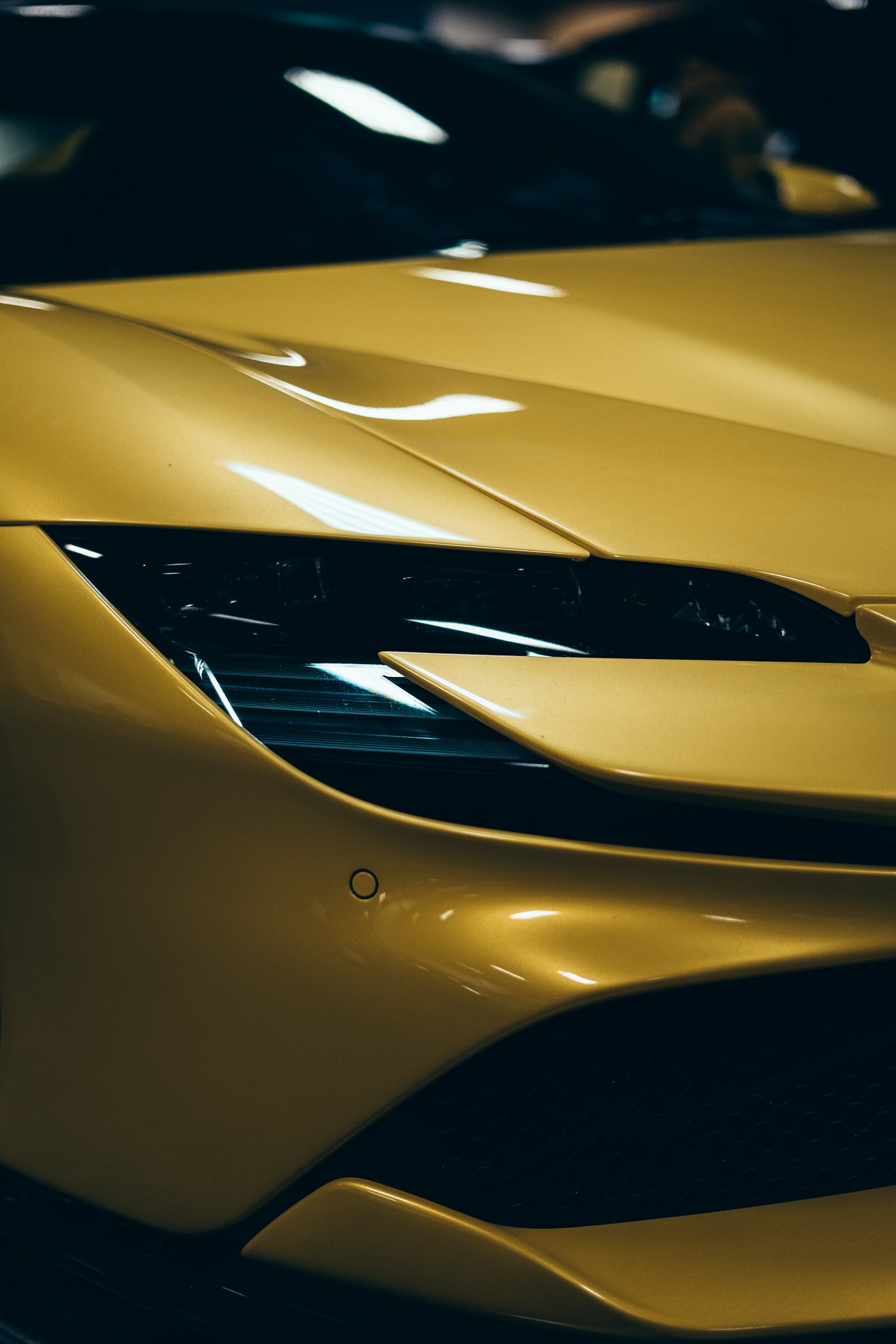 a close up of a yellow sports car