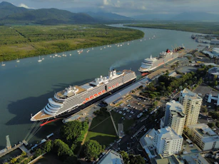 a cruise ship docked in a harbor next to a city