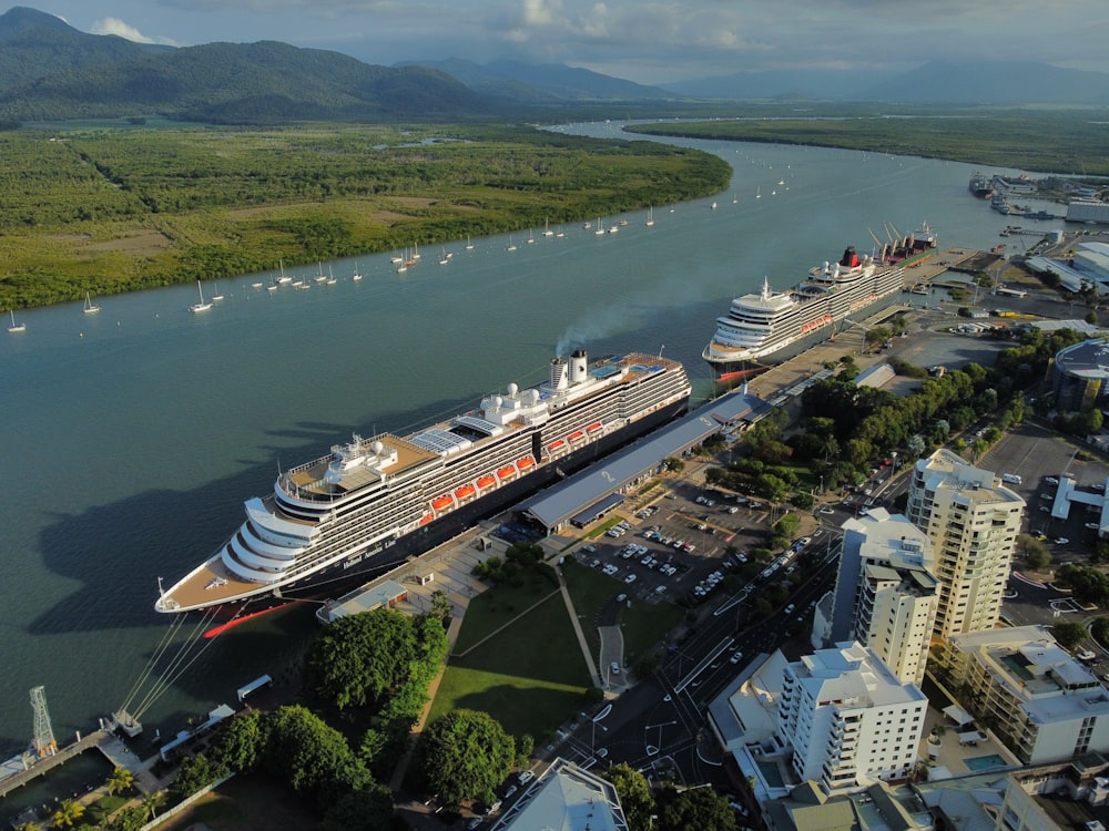 a cruise ship docked in a harbor next to a city