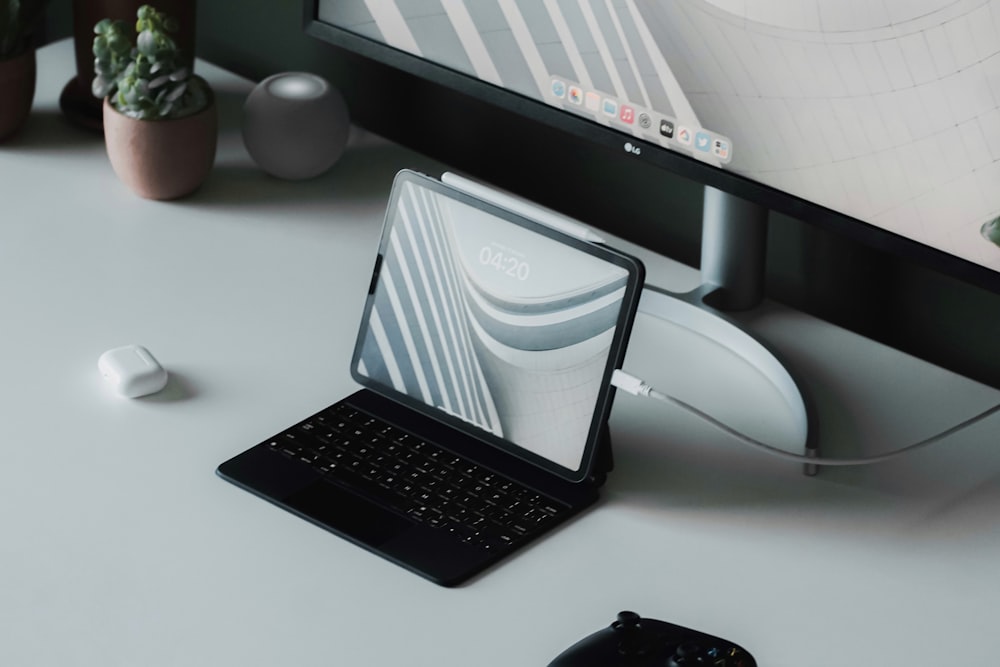 a laptop computer sitting on top of a white desk