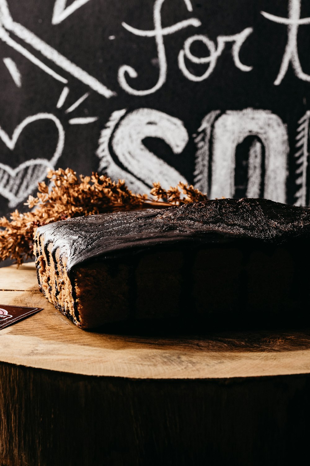 a piece of chocolate cake sitting on top of a wooden table