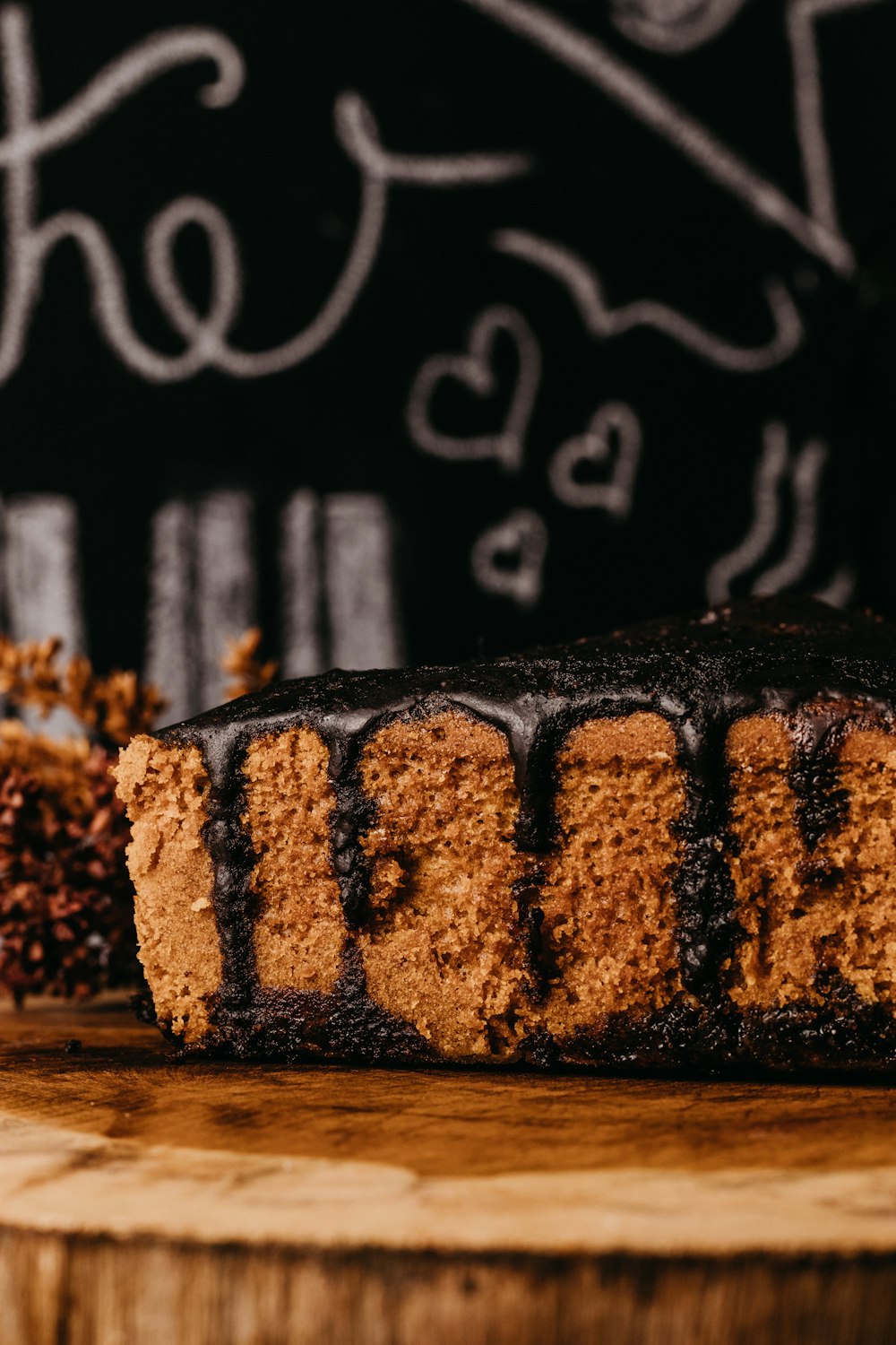 a piece of cake sitting on top of a wooden cutting board