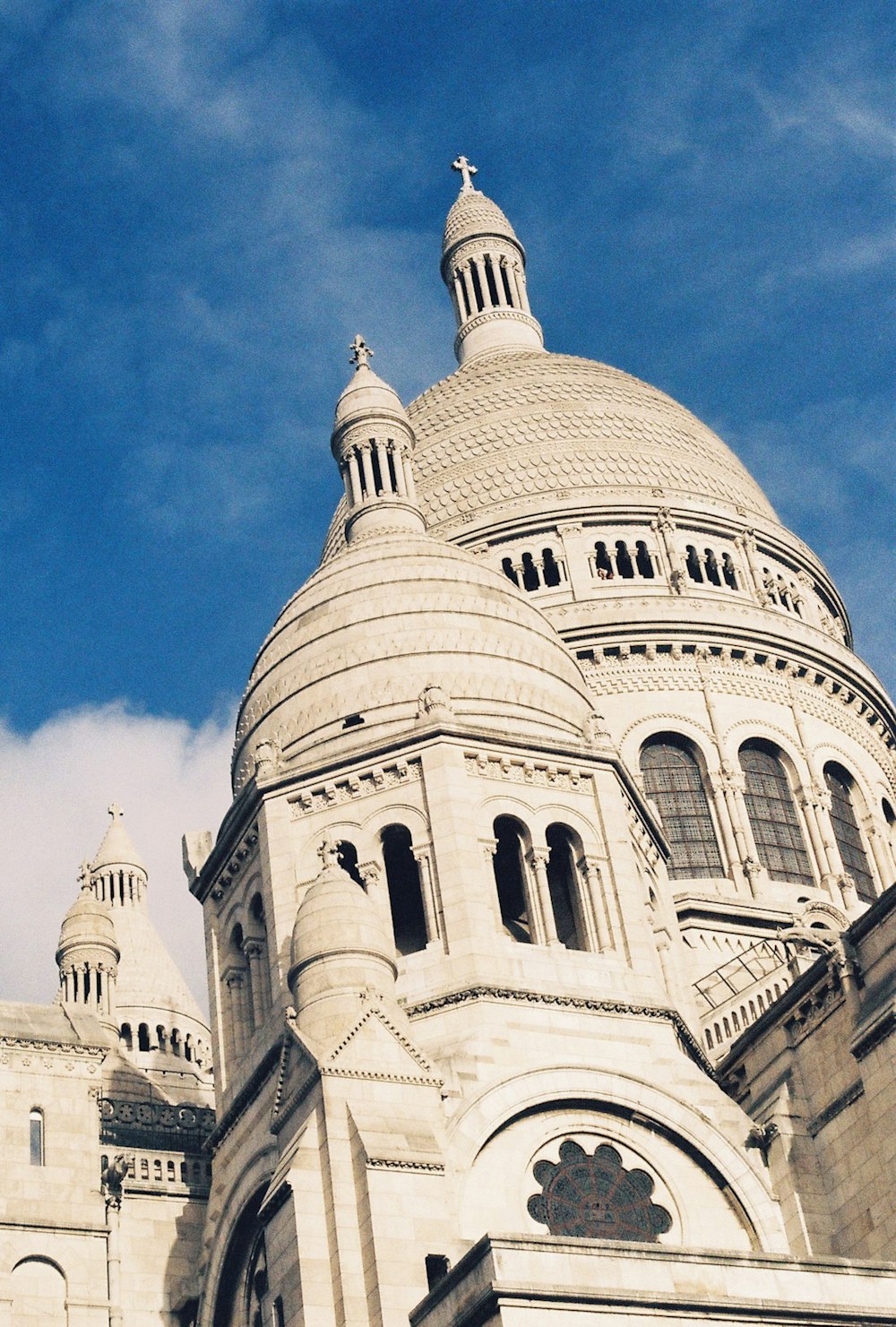 a large white building with a clock on it's side